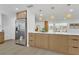 Open concept kitchen with stainless steel refrigerator, and breakfast bar at 2837 Woodcrest Dr, Sarasota, FL 34239