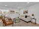 Bright living room featuring a white sofa, neutral decor, and light wood flooring at 2837 Woodcrest Dr, Sarasota, FL 34239