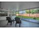 Screened patio with chairs and open views of the backyard and fence, perfect for outdoor living and relaxation at 2837 Woodcrest Dr, Sarasota, FL 34239