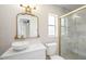 Bathroom with glass shower, white marble, white vanity, decorative gold-framed mirror, and bright lighting at 2905 Forest Cir, Seffner, FL 33584
