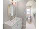 Neutral toned bathroom with decorative mirror, modern faucet and fixtures, with access to the shower at 2905 Forest Cir, Seffner, FL 33584