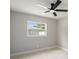 Bright neutral bedroom with hard surface floors, a ceiling fan, and a large window with natural light at 2905 Forest Cir, Seffner, FL 33584