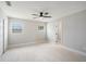 Neutral bedroom with tile floors, ceiling fan, closet and large windows with natural light at 2905 Forest Cir, Seffner, FL 33584
