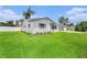 Side view of a well-maintained home with a lush green lawn and white picket fence at 2905 Forest Cir, Seffner, FL 33584