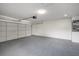 Spacious garage with epoxy floor, white walls, and ample space for parking and storage at 2905 Forest Cir, Seffner, FL 33584