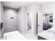 Bathroom featuring walk-in shower, soaking tub, marble floor and gray vanity at 3005 1St N Ave, St Petersburg, FL 33713
