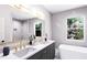 Bathroom with double sinks, large mirror, soaking tub and natural light at 3005 1St N Ave, St Petersburg, FL 33713
