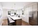 Bright, modern kitchen with island, stainless steel appliances, white cabinets, and hardwood floors at 3005 1St N Ave, St Petersburg, FL 33713