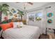 Unique bedroom features colorful decor, a large window, and comfortable furnishings for a vibrant space at 3015 Florida Blvd, Bradenton, FL 34207
