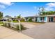 Exterior view of a cozy home with white picket fence, blue shutters, and well-maintained landscaping at 3015 Florida Blvd, Bradenton, FL 34207