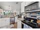 Bright kitchen featuring stainless steel appliances, granite countertops, white cabinets, and views into the living area at 3015 Florida Blvd, Bradenton, FL 34207