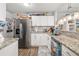 Modern kitchen with stainless steel appliances, granite countertops, and bright white cabinets at 3015 Florida Blvd, Bradenton, FL 34207