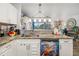 Bright kitchen features granite countertops, white cabinets, a unique dishwasher, and a stainless steel sink at 3015 Florida Blvd, Bradenton, FL 34207