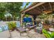 This covered patio features an outdoor living space with comfortable wicker furniture and decor at 3015 Florida Blvd, Bradenton, FL 34207