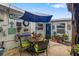 This cozy patio features an umbrella covered table and chair set with surrounding decor at 3015 Florida Blvd, Bradenton, FL 34207