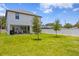 Spacious backyard with well-maintained lawn, fence, and covered patio, perfect for outdoor activities at 303 N Beverly Ave, Tampa, FL 33609