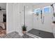 Modern bathroom featuring a glass-enclosed shower with white subway tile and decorative tile flooring at 303 N Beverly Ave, Tampa, FL 33609