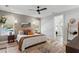 Well-lit bedroom with textured accent wall, stylish furnishings, and an attached bathroom at 303 N Beverly Ave, Tampa, FL 33609