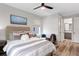 Well-lit bedroom features a comfortable bed, sitting area, and neutral decor with wood laminate flooring at 303 N Beverly Ave, Tampa, FL 33609