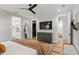Spacious bedroom with hardwood floors, a ceiling fan, and access to en-suite bathroom and walk-in closet at 303 N Beverly Ave, Tampa, FL 33609