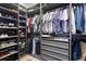 Walk-in closet features custom shelving, hanging racks, and pull-out drawers for organized storage at 303 N Beverly Ave, Tampa, FL 33609