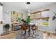 Cozy dining area with a round table, modern chairs, and natural light from a nearby window at 303 N Beverly Ave, Tampa, FL 33609