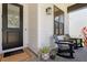 Charming front porch features seating area, plants and a decorative door adding curb appeal to the house at 303 N Beverly Ave, Tampa, FL 33609