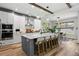 Bright, open kitchen features a large island with seating, modern appliances, and stylish pendant lighting at 303 N Beverly Ave, Tampa, FL 33609