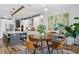 Modern kitchen with island, pendant lights, dining area, and stylish decor at 303 N Beverly Ave, Tampa, FL 33609