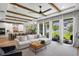 Spacious living room features wood beams, modern decor, and seamless flow to the kitchen at 303 N Beverly Ave, Tampa, FL 33609
