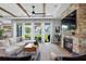 Bright living area boasts a stone fireplace, modern decor, and seamless flow to the backyard at 303 N Beverly Ave, Tampa, FL 33609