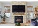 Stylish living room features a stone fireplace with an integrated TV, and natural lighting at 303 N Beverly Ave, Tampa, FL 33609