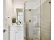 Modern bathroom with glass shower, stone floor, and white vanity at 3100 W Paul Ave # 15, Tampa, FL 33611