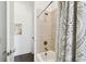 Clean bathroom with tiled shower, soaking tub and patterned shower curtain at 3100 W Paul Ave # 15, Tampa, FL 33611