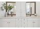 Well-lit bathroom with dual sinks, white cabinets, and modern fixtures at 3100 W Paul Ave # 15, Tampa, FL 33611