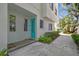 A modern townhouse entrance with a vibrant blue door and well-manicured landscaping at 3100 W Paul Ave # 15, Tampa, FL 33611