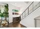 Hallway featuring hardwood floors, a modern staircase, and stylish decor at 3100 W Paul Ave # 15, Tampa, FL 33611