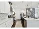 Modern kitchen featuring stainless steel appliances, white cabinets, and a large center island at 3100 W Paul Ave # 15, Tampa, FL 33611