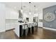 Bright, open kitchen featuring white cabinets, stainless steel appliances, and stylish pendant lighting at 3100 W Paul Ave # 15, Tampa, FL 33611