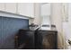 Laundry room with front load black washer and dryer at 3100 W Paul Ave # 15, Tampa, FL 33611