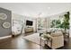 A modern living room featuring hardwood floors, a large area rug, and lots of natural light at 3100 W Paul Ave # 15, Tampa, FL 33611