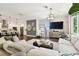 Spacious open-concept living room featuring dark wood floors and modern furnishings at 3100 W Paul Ave # 15, Tampa, FL 33611