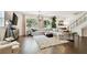 Bright and airy living room featuring a large sectional sofa, hardwood floors and big windows at 3100 W Paul Ave # 15, Tampa, FL 33611