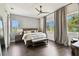 Serene bedroom featuring a king-sized bed, decorative wall, and large windows at 3100 W Paul Ave # 15, Tampa, FL 33611
