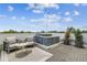 Relaxing rooftop patio with hot tub, outdoor seating and manicured plants at 3100 W Paul Ave # 15, Tampa, FL 33611