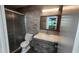 Modern bathroom with gray tile, updated vanity, and glass enclosed shower at 3123 29Th N Ave # 105, St Petersburg, FL 33713