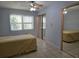 Bedroom with tile flooring, mirrored closet doors, and a ceiling fan at 3123 29Th N Ave # 105, St Petersburg, FL 33713
