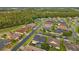 Beautiful aerial of a residential community with well-manicured lawns, a scenic lake, and surrounding trees at 31646 Baymont Loop, Wesley Chapel, FL 33543