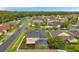 The aerial view shows the back of the house with the screened pool, patio, and a large yard at 31646 Baymont Loop, Wesley Chapel, FL 33543