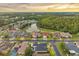 Stunning aerial view of lakeside community featuring manicured landscaping and gorgeous homes at sunset at 31646 Baymont Loop, Wesley Chapel, FL 33543